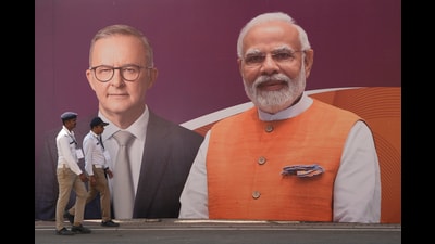 Policemen walk past a hoarding featuring Prime Minister Narendra Modi and his Australian counterpart Anthony Albanese, Ahmedabad, March 8, 2023 (AP) Policemen walk past a hoarding featuring Prime Minister Narendra Modi and his Australian counterpart Anthony Albanese, Ahmedabad, March 8, 2023 (AP)