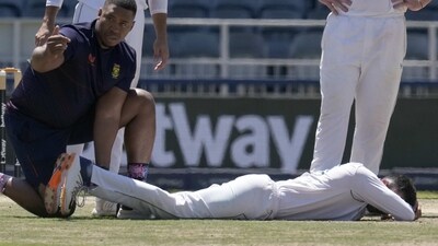 South Africa's bowler Keshav Maharaj on the lies on the ground after twisting his left foot while celebrating his second wicket (AP)