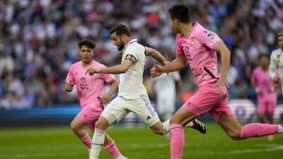 Real Madrid's Nacho, center, dribbles between Espanyol players (AP) Real Madrid's Nacho, center, dribbles between Espanyol players (AP)