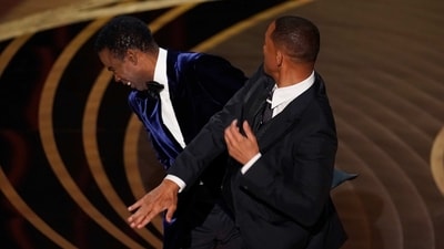 Will Smith, right, hits presenter Chris Rock on stage at the Oscars. (AP) (Chris Pizzello/Invision/AP) Will Smith, right, hits presenter Chris Rock on stage at the Oscars. (AP) (Chris Pizzello/Invision/AP)