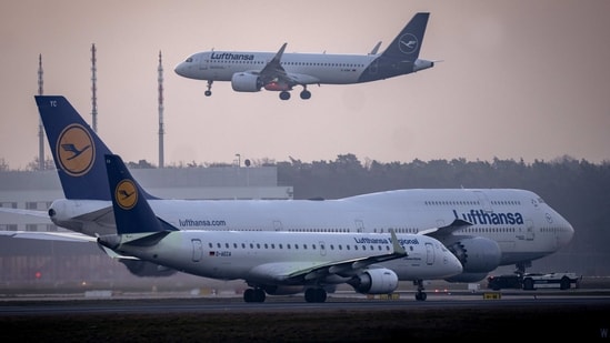 A Lufthansa aircraft lands while two others wait at the airport in Frankfurt, Germany, Friday, March 3. (AP)