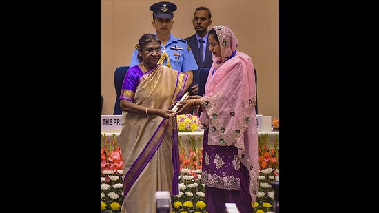 President Droupadi Murmu presents the Swachh Sujal Shakti Samman 2023 for waste management to Peroshah village in Punjab's Gurdaspur district. Harjinder Kaur, the sarpanch of the village, received the award. (PTI photo)