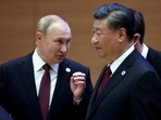 Russian President Vladimir Putin speaks with Chinese President Xi Jinping.