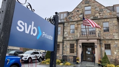 Vehicles are parked outside a Silicon Valley Bank branch in Wellesley, Mass., on Saturday, (AP) Vehicles are parked outside a Silicon Valley Bank branch in Wellesley, Mass., on Saturday, (AP)
