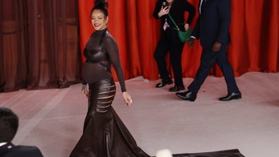 Rihanna, who is pregnant, walked the champagne-coloured red carpet during the Oscars 2023 arrivals at the 95th Academy Awards in Hollywood, Los Angeles, California, US on March 12, 2023, in a darkly sexy look of a black leather Alaia gown that gave maternity fashion a new twist and made jaws drop in awe.&nbsp; (REUTERS/Aude Guerrucci)