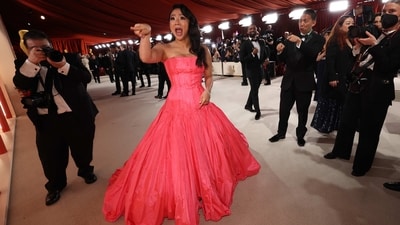 Stephanie Hsu poses on the champagne-coloured red carpet during the Oscars ceremony. She chose a bubblegum pink strapless Valentino gown. She is nominee for Best Actress in a Supporting Role category.&nbsp; (REUTERS)