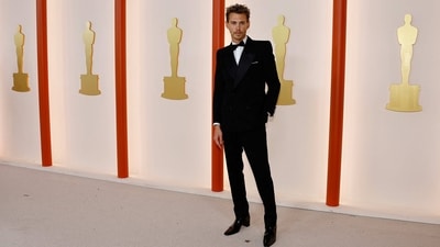 Austin Butler poses on the champagne-coloured red carpet during the Oscars ceremony in a Saint Laurent tuxedo.&nbsp; (REUTERS)
