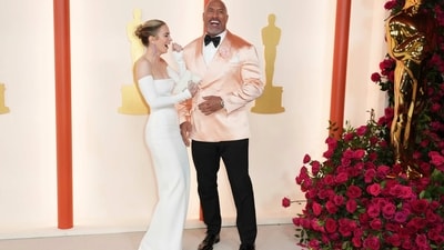 Emily Blunt attended the 95th Oscars ceremony in a white off the shoulder gown from the Valentino Urban Riviera collection. She poses here with Dwayne Johnson. (Jordan Strauss/Invision/AP) Emily Blunt attended the 95th Oscars ceremony in a white off the shoulder gown from the Valentino Urban Riviera collection. She poses here with Dwayne Johnson. (Jordan Strauss/Invision/AP)