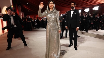 Malala Yousafzai made her Oscars debut in a silver sequinned hooded gown by Ralph Lauren. She attended with her husband, Asser Malik.&nbsp; (REUTERS)