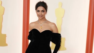 Deepika Padukone made her debut at the Oscars awards ceremony in a black off-the-shoulder gown from the fashion house Louis Vuitton. Deepika styled the gorgeous ensemble with jewels from Cartier, minimal makeup and a messy low bun. She also showed off her new neck tattoo on the carpet. (Jordan Strauss/Invision/AP) Deepika Padukone made her debut at the Oscars awards ceremony in a black off-the-shoulder gown from the fashion house Louis Vuitton. Deepika styled the gorgeous ensemble with jewels from Cartier, minimal makeup and a messy low bun. She also showed off her new neck tattoo on the carpet. (Jordan Strauss/Invision/AP)