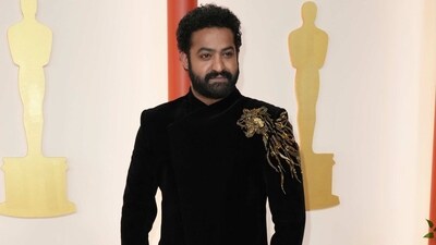 RRR actor Jr NTR attends the Oscars Award ceremony in a black bandhgala sherwani designed specially for him by Gaurav Gupta. The ensemble features an embellished tiger motif representing India. (Jordan Strauss/Invision/AP) RRR actor Jr NTR attends the Oscars Award ceremony in a black bandhgala sherwani designed specially for him by Gaurav Gupta. The ensemble features an embellished tiger motif representing India. (Jordan Strauss/Invision/AP)