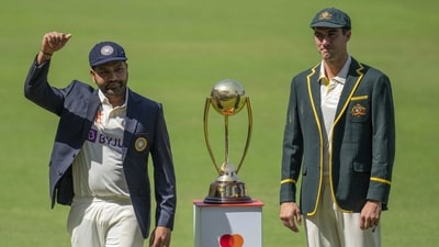 India's captain Rohit Sharma, left, and Australia's captain Pat Cummins pose with the Border–Gavaskar Trophy (AP)