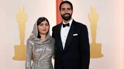 Malala Yousafzai and Asser Malik at the Oscars on Sunday. For the event, Malala wore a silver dress while Asser opted for a white shirt, black blazer and pants. (AP) Malala Yousafzai and Asser Malik at the Oscars on Sunday. For the event, Malala wore a silver dress while Asser opted for a white shirt, black blazer and pants. (AP)