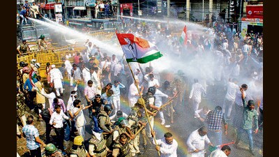 Police use water cannons to disperse Congress workers during a protest march to Raj Bhavan, in Bhopal, on Monday. (PTI)