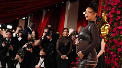 Rihanna, who is set to become a mother, arrives at the Oscars on Sunday. The singer wore a black bodycon dress for the event. (AP) Rihanna, who is set to become a mother, arrives at the Oscars on Sunday. The singer wore a black bodycon dress for the event. (AP)