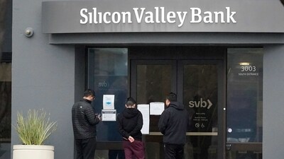 People look at signs posted outside of an entrance to Silicon Valley Bank in Santa Clara. (AP) People look at signs posted outside of an entrance to Silicon Valley Bank in Santa Clara. (AP)