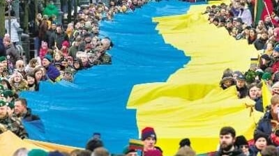 People carry a giant Ukrainian flag to protest against the Russian invasion during a celebration of 33rd anniversary of Lithuania’s independence from the Soviet Union, in Vilnius on Saturday. (AP) People carry a giant Ukrainian flag to protest against the Russian invasion during a celebration of 33rd anniversary of Lithuania’s independence from the Soviet Union, in Vilnius on Saturday. (AP)