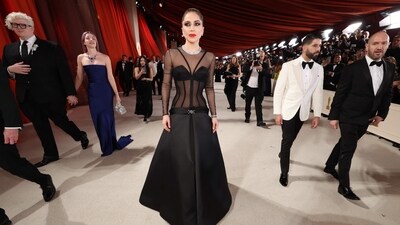 Lady Gaga makes her way down the champagne-colored red carpet during the Oscars arrivals at the 95th Academy Awards in Hollywood, Los Angeles, California. For the event, she wore a long dress. (REUTERS) 