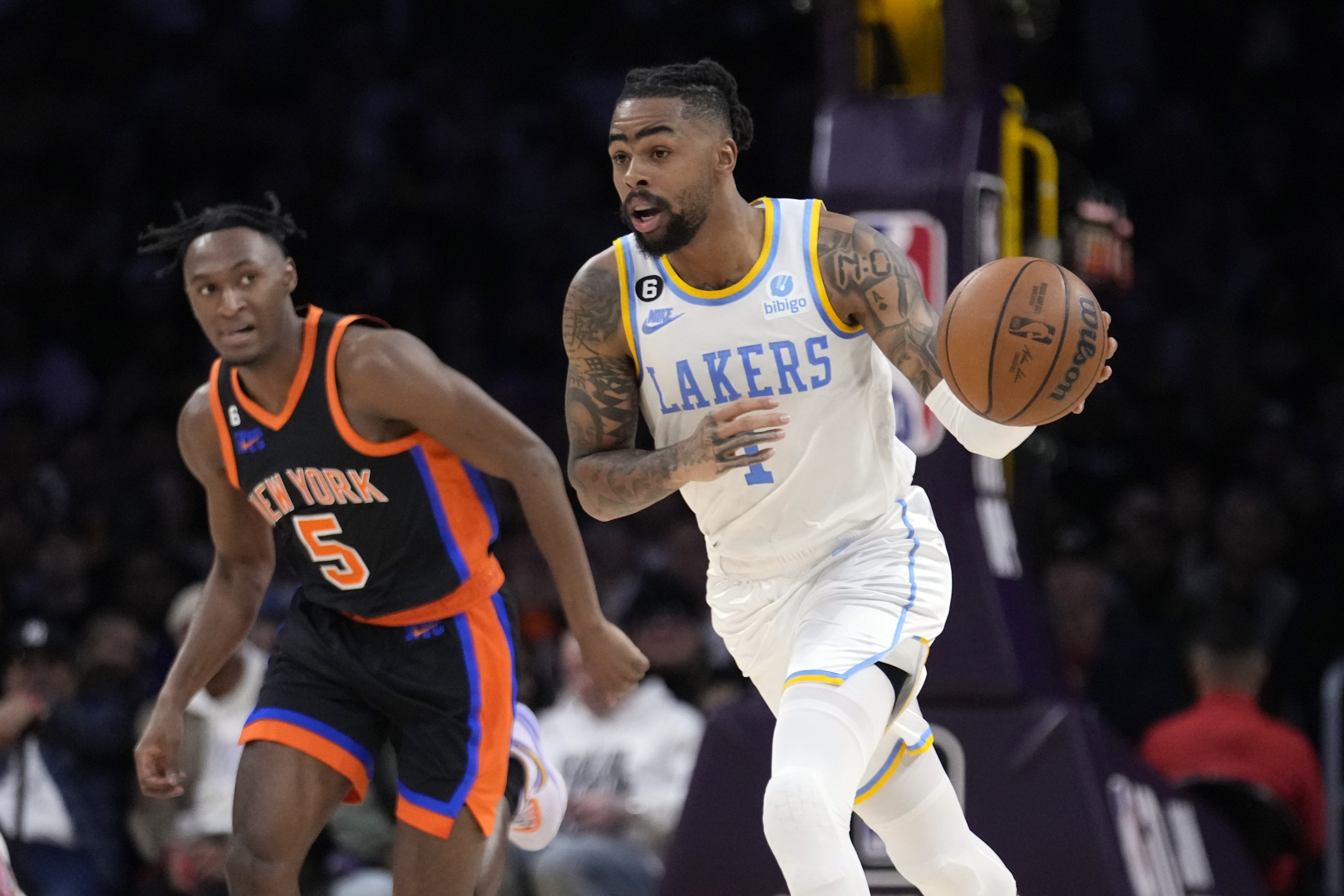 Los Angeles Lakers guard D'Angelo Russell, right, dribbles past New York Knicks guard Immanuel Quickley (5) during the first half of an NBA basketball game Sunday, March 12, 2023, in Los Angeles. (AP) Los Angeles Lakers guard D'Angelo Russell, right, dribbles past New York Knicks guard Immanuel Quickley (5) during the first half of an NBA basketball game Sunday, March 12, 2023, in Los Angeles. (AP)