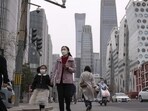 China Resumes Issuing Visas: Pedestrian and motorists cross a traffic intersection near the Central Business District in Beijing.