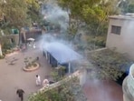 Police fire tear gas into Imran Khan's Lahore house.