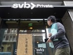 A pedestrian passes a Silicon Valley Bank Private branch in San Francisco on Monday.