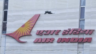 A bird flies over a logo of Air India airlines at the corporate headquarters in Mumbai, India. (REUTERS)
