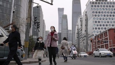 China Resumes Issuing Visas: Pedestrian and motorists cross a traffic intersection near the Central Business District in Beijing. (AP) China Resumes Issuing Visas: Pedestrian and motorists cross a traffic intersection near the Central Business District in Beijing. (AP)