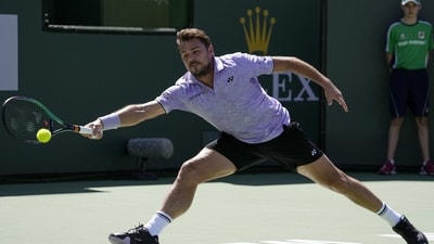 Stan Wawrinka, of Switzerland, serves to Holger Rune, of Denmark, at the BNP Paribas Open tennis tournament Monday, March 13, 2023, in Indian Wells, Calif. (AP Photo/Mark J. Terrill) (AP) Stan Wawrinka, of Switzerland, serves to Holger Rune, of Denmark, at the BNP Paribas Open tennis tournament Monday, March 13, 2023, in Indian Wells, Calif. (AP Photo/Mark J. Terrill) (AP)