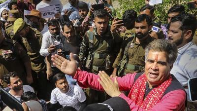 J&K BJP president Ravinder Raina trying to pacify job aspirants in Jammu on Tuesday. (PTI)