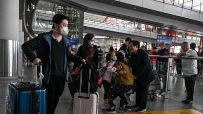 Passengers walk through the arrivals hall for international flights at the Capital International Airport in Beijing on Monday. (AFP) Passengers walk through the arrivals hall for international flights at the Capital International Airport in Beijing on Monday. (AFP)