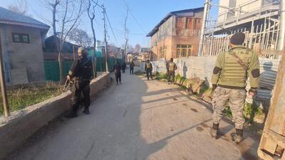 Security personnel stand guard during a raid conducted by NIA, in Jammu and Kashmir on Tuesday. (PTI)