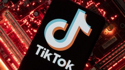 A smartphone with a displayed TikTok logo is placed on a computer motherboard in this illustration. (REUTERS)