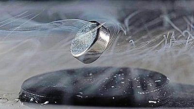 A magnet floats above a superconductor cooled with liquid nitrogen. (University of Rochester) A magnet floats above a superconductor cooled with liquid nitrogen. (University of Rochester)