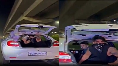 Man throwing currency notes from his running car in Gurugram. Man throwing currency notes from his running car in Gurugram.