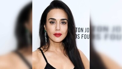 Preity Zinta's gown features a plunging neckline and floor-sweeping detailings. She accessorised her gown with a simple black purse. (Instagram/@realpz) Preity Zinta's gown features a plunging neckline and floor-sweeping detailings. She accessorised her gown with a simple black purse. (Instagram/@realpz)