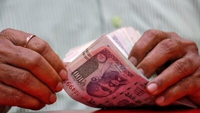 A man counts Indian currency notes inside a shop in Mumbai. (REUTERS) A man counts Indian currency notes inside a shop in Mumbai. (REUTERS)