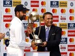 Cricket - Fourth Test - India v Australia - Narendra Modi Stadium, Ahmedabad, India - March 13, 2023 India's Rohit Sharma receives the Border Gavaskar trophy from Sunil Gavaskar after winning the test series REUTERS/Amit Dave