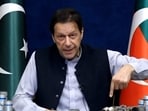 This screengrab from Pakistan Tehreek-e-Insaf via AFPTV taken on March 15, 2023 shows former Pakistan prime minister Imran Khan issuing a video statement with a display of spent teargas canisters that he claims were fired into his home in Lahore. (AFP)