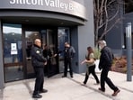 A customer is escorted into the Silicon Valley Bank headquarters in Santa Clara, California, U.S.