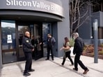 A customer is escorted into the Silicon Valley Bank headquarters in Santa Clara, California, U.S.