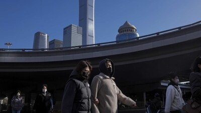 China Flu Outbreak: People wearing face masks walk through a flyover near the Central Business District in Beijing. (AP) China Flu Outbreak: People wearing face masks walk through a flyover near the Central Business District in Beijing. (AP)