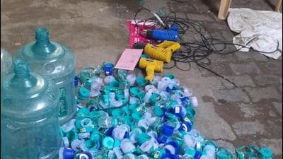 Fake canisters and caps of a bottled water company found at the purifying unit in Palam Vihar on Wednesday. (HT PHOTO)