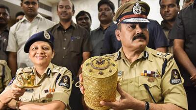 Police Commissioner Anjani Kumar shows the three-tier golden tiffin box after it was recovered from thieves in Hyderabad. Several priceless objects went missing from the Nizam Museum at Purani Haveli in the city but were recovered. (PTI)