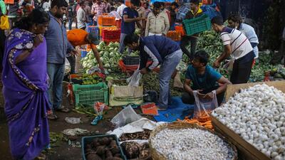 Vegetable vendors and customers at a wholesale vegetable market in Bengaluru. (Bloomberg File Photo) Vegetable vendors and customers at a wholesale vegetable market in Bengaluru. (Bloomberg File Photo)