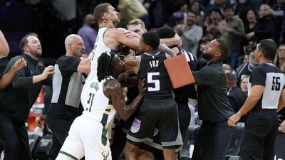 Brook Lopez #11 of the Milwaukee Bucks and Trey Lyles #41 of the Sacramento Kings gets tangled up in a fight while teammates Jrue Holiday #21 of the Bucks and De'Aaron Fox #5 of the Kings attempt to come in between them late in fourth quarter at Golden 1 Center on March 13, 2023 in Sacramento, California. (Getty Images via AFP)