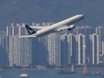 FILE PHOTO: A Cathay Pacific aircraft takes off at the airport, during the coronavirus disease (COVID-19) pandemic in Hong Kong, China, March 31, 2022. REUTERS/Tyrone Siu/File Photo
