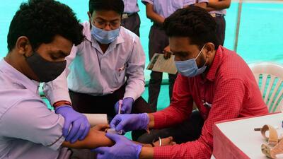 A health worker collects blood sample of a person as a precaution against the H3N2 virus. (AFP Photo)