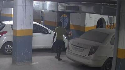 A video grab shows Ramraj pouring acid on a car belonging to one of his former employers. (HT Photo) A video grab shows Ramraj pouring acid on a car belonging to one of his former employers. (HT Photo)
