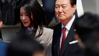 Yoon Suk Yeol In Japan: South Korea's President Yoon Suk Yeol and his wife Kim Keon-hee look on at Tokyo International Airport (Haneda Airport) in Tokyo, Japan. (Reuters)
